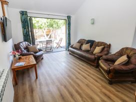A living room with leather sofas and a coffee table at Brookview Goldfinch in Haverfordwest