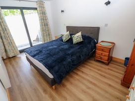 A bedroom with a bed and bedside table at Brookview Goldfinch in Haverfordwest