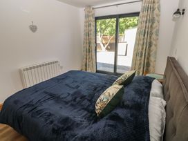 A bedroom with a bed and window at Brookview Goldfinch in Haverfordwest