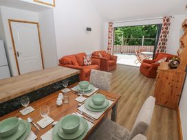 A living room with sofa and dining table at Brookview Goldfinch in Haverfordwest