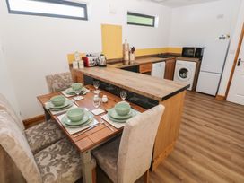 A kitchen with dining table and chairs at Brookview Goldfinch in Haverfordwest