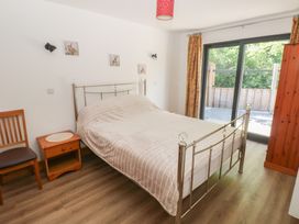 A bedroom with a bed and side table at Brookview Goldfinch in Haverfordwest