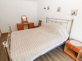 A bedroom with a bed and dressing table at Brookview Goldfinch in Haverfordwest
