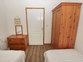 A bedroom with a wardrobe and chest of drawers at Brookview Goldfinch Haverfordwest