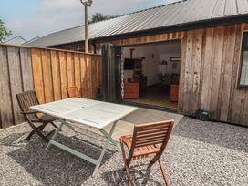 An outdoor seating area with a table and chairs at Brookview Goldfinch in Haverfordwest