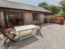 An outdoor area with a table and chairs at Brookview Goldfinch in Haverfordwest