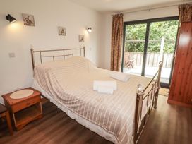A bedroom with a bed and bedside table at Brookview Goldfinch in Haverfordwest
