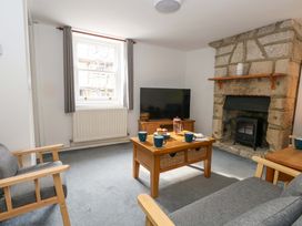 A living room with a fireplace and tv at NO 10 Fortuneswell