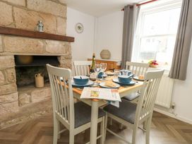 A dining room with a table set for a meal at NO 10 in Fortuneswell