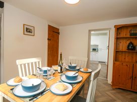 A dining room with a table set for meals at NO 10 Fortuneswell