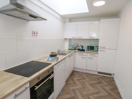 A kitchen with stove, oven, sink, and microwave at NO 10 Fortuneswell