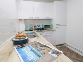 A kitchen with a sink and microwave at NO 10 in Fortuneswell