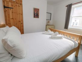 A bedroom with a bed and dresser at NO 10 in Fortuneswell