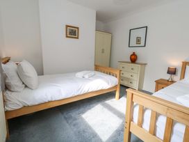 A bedroom with two beds and furniture at NO 10 in Fortuneswell