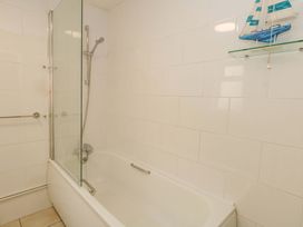 A bathroom with a bathtub and shower at NO 10 in Fortuneswell