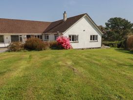 A house with a garden and flower bushes at Tregoning annex Lerryn near Lostwithiel
