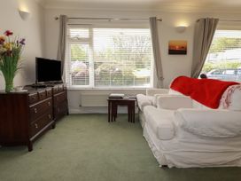 A living room with a sofa and television at Tregoning annex Lerryn near Lostwithiel