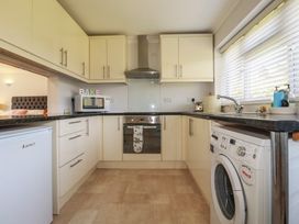 A kitchen with appliances and cabinets at Tregoning annex Lerryn near Lostwithiel
