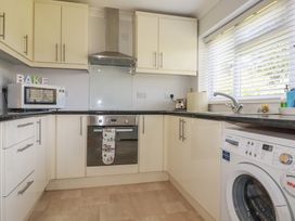 A kitchen with appliances and cabinets at Tregoning annex in Lerryn near Lostwithiel