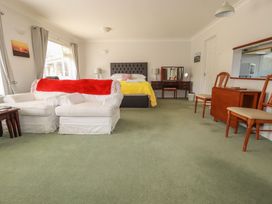 A bedroom with a bed and sofa at Tregoning annex in Lerryn near Lostwithiel