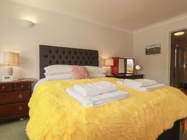 A bedroom with a bed and bedside table at Tregoning annex in Lerryn near Lostwithiel