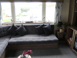 A living room with a sofa and window at Kent Coast Holiday Park - Holiday Accommodation 22252, Rochester, Kent
