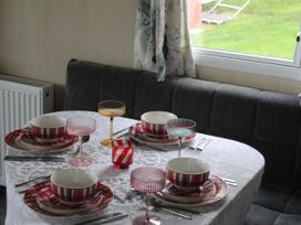 A dining table set with dishes and glassware at Kent Coast Holiday Park - Holiday Accommodation 22252 Rochester, Kent