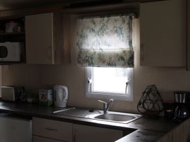 A kitchen with a sink and appliances at Kent Coast Holiday Park - Holiday Accommodation 22252, Rochester, Kent