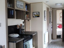 A kitchen with stove and utensils at Kent Coast Holiday Park - Holiday Accommodation 22252, Rochester, Kent