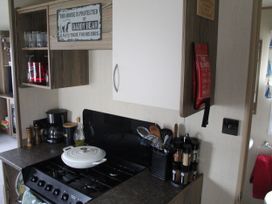 A kitchen with a stove and various appliances at Kent Coast Holiday Park - Holiday Accommodation 22252, Rochester, Kent