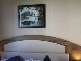 A painting of a bird above a bed at Kent Coast Holiday Park - Holiday Accommodation 22252, Rochester, Kent