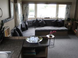 A living room with a sofa and coffee table at Kent Coast Holiday Park - Holiday Accommodation 22252, Rochester, Kent