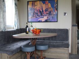 A dining area with a table and seating at Kent Coast Holiday Park - Holiday Accommodation 22252 in Rochester, Kent