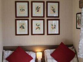 A bedroom with framed artwork above the bed at Kent Coast Holiday Park - Holiday Accommodation 22252 in Rochester, Kent