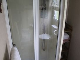 A shower and toilet in a bathroom at Kent Coast Holiday Park - Holiday Accommodation 22252 in Rochester, Kent
