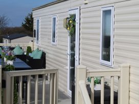 A balcony with table and chairs at Kent Coast Holiday Park - Holiday Accommodation 22252, Rochester, Kent