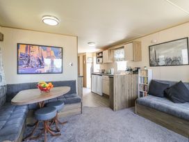A living room with a sofa and coffee table at Estuary View in Allhallows