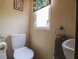 A bathroom with a toilet and a window at Estuary View in Allhallows