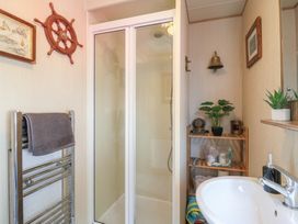 A bathroom with a shower and sink at Estuary View in Allhallows