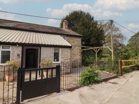 A house with a gated entrance and plants around at Harbins Farm in Glanvilles Wootton Nr. Sherborne