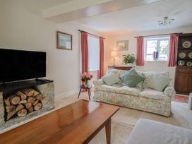 A living room with a sofa and television at Harbins Farm in Glanvilles Wootton Nr. Sherborne