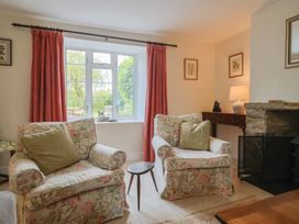 A living room with floral sofas and a lamp at Harbins Farm Glanvilles Wootton Nr. Sherborne