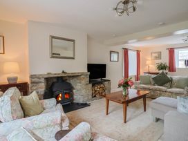 A living room with a fireplace and sofa at Harbins Farm, Glanvilles Wootton Nr. Sherborne