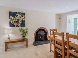 A dining room with a fireplace and a dining table at Harbins Farm Glanvilles Wootton Nr. Sherborne
