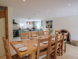 A dining room with a large table and kitchen in Harbins Farm Glanvilles Wootton Nr. Sherborne