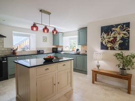 A kitchen with an island and various appliances at Harbins Farm Glanvilles Wootton Nr. Sherborne