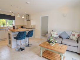 An open plan kitchen and living area with a sofa and coffee table at Harbins Farm in Glanvilles Wootton Nr. Sherborne