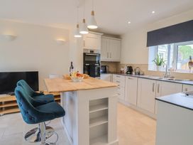 A kitchen with a breakfast bar and appliances at Harbins Farm Glanvilles Wootton Nr. Sherborne
