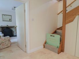 A hallway with a staircase and a sign at Harbins Farm in Glanvilles Wootton Nr. Sherborne
