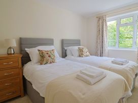 A bedroom with two single beds and a dresser at Harbins Farm, Glanvilles Wootton Nr. Sherborne